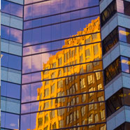A building reflecting in the windows of another building