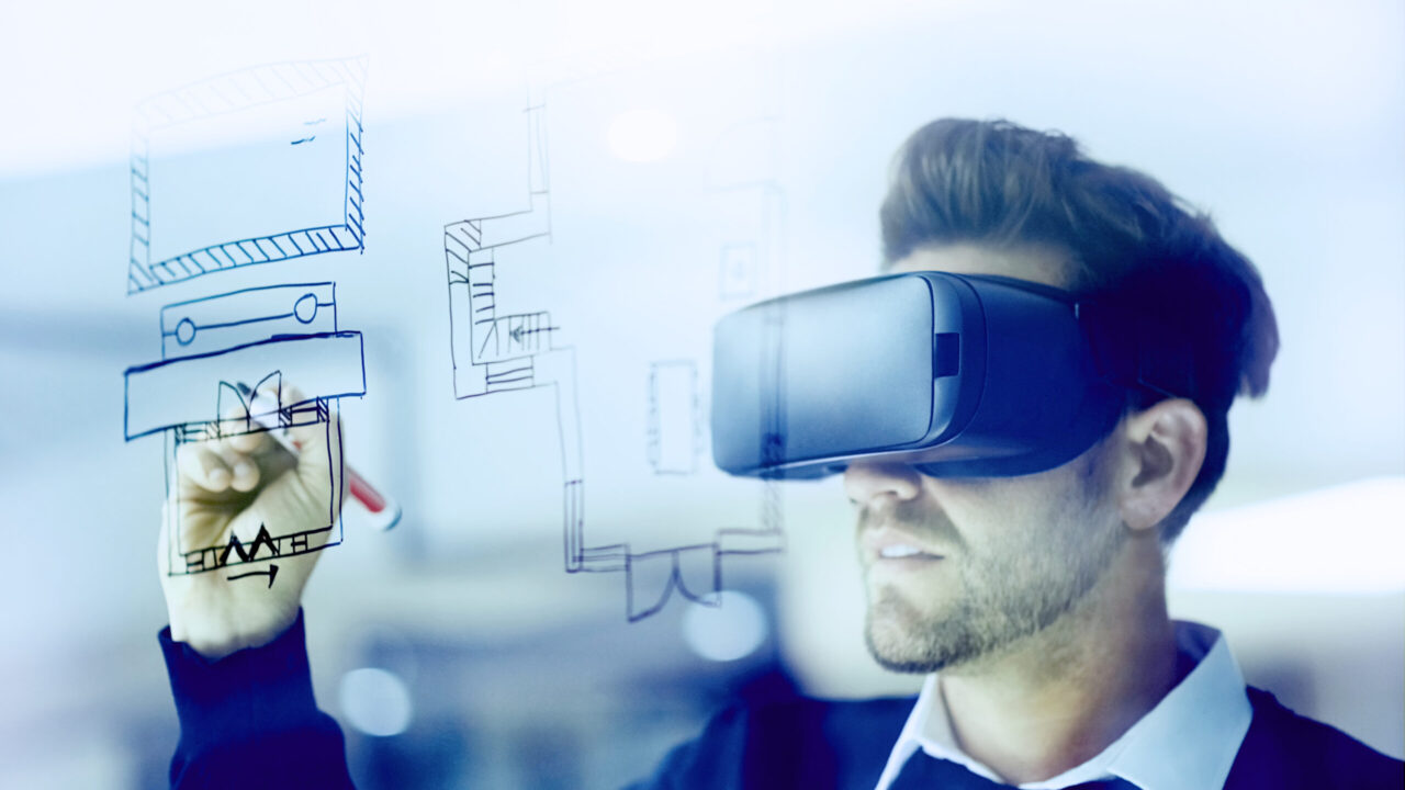 Shot of a businessman wearing a VR headset while drawing on a glass wall in an office