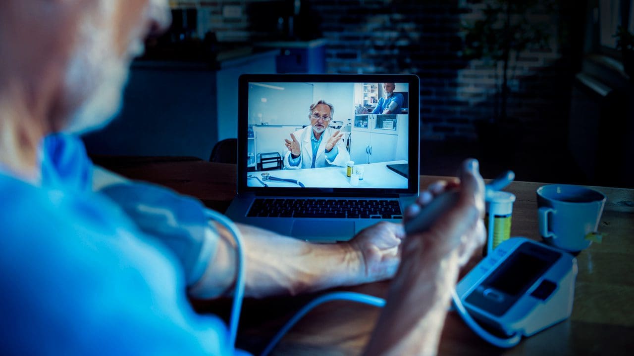 Healthcare and Life Sciences: man consulting doctor virtually.