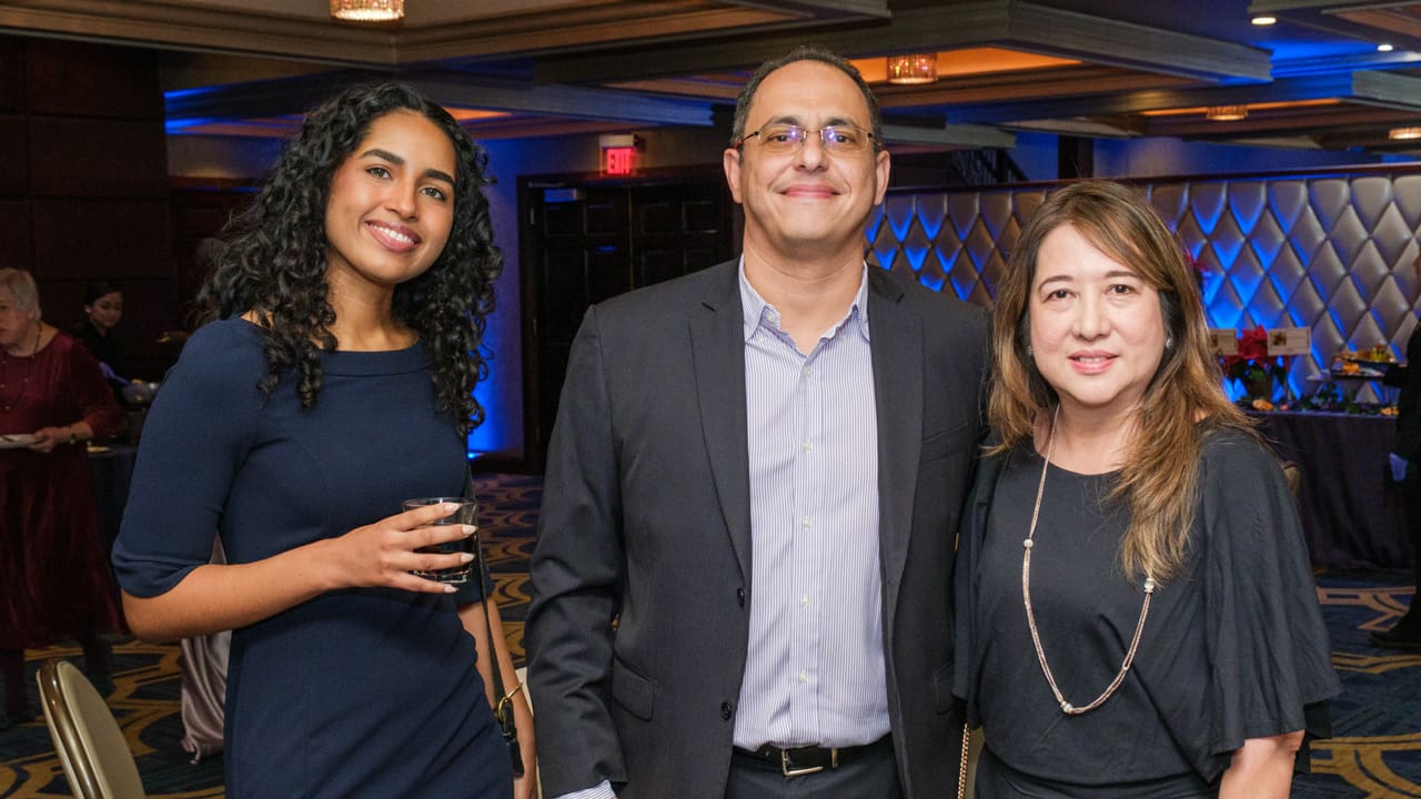 Three people posing for picture