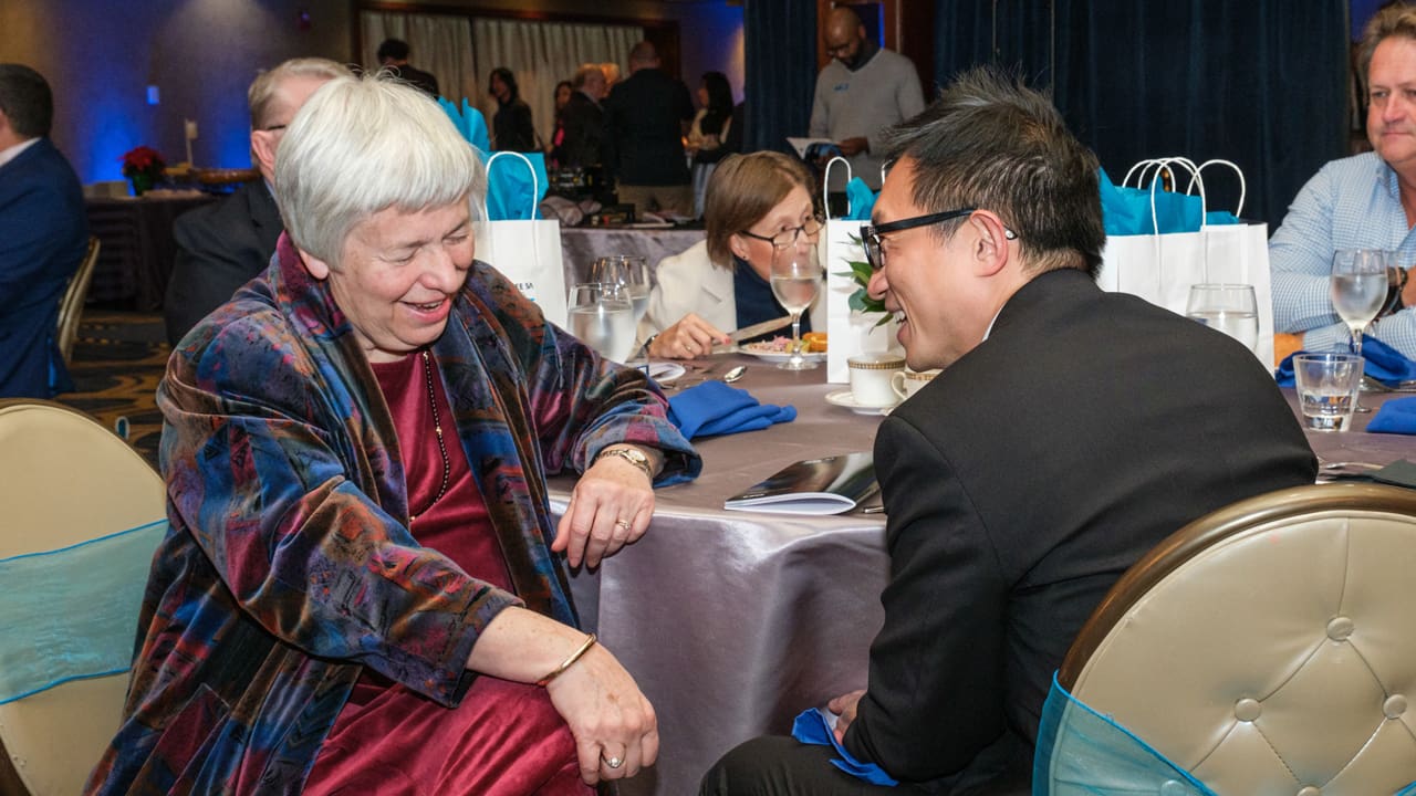 Two people talking at table