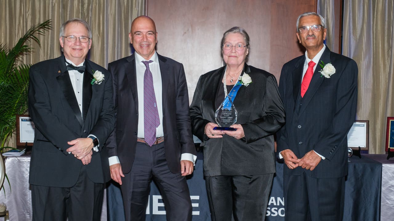 Recipient posing with award