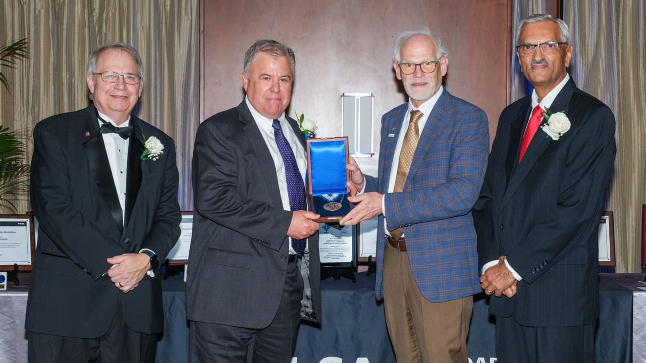 Recipient posing with award