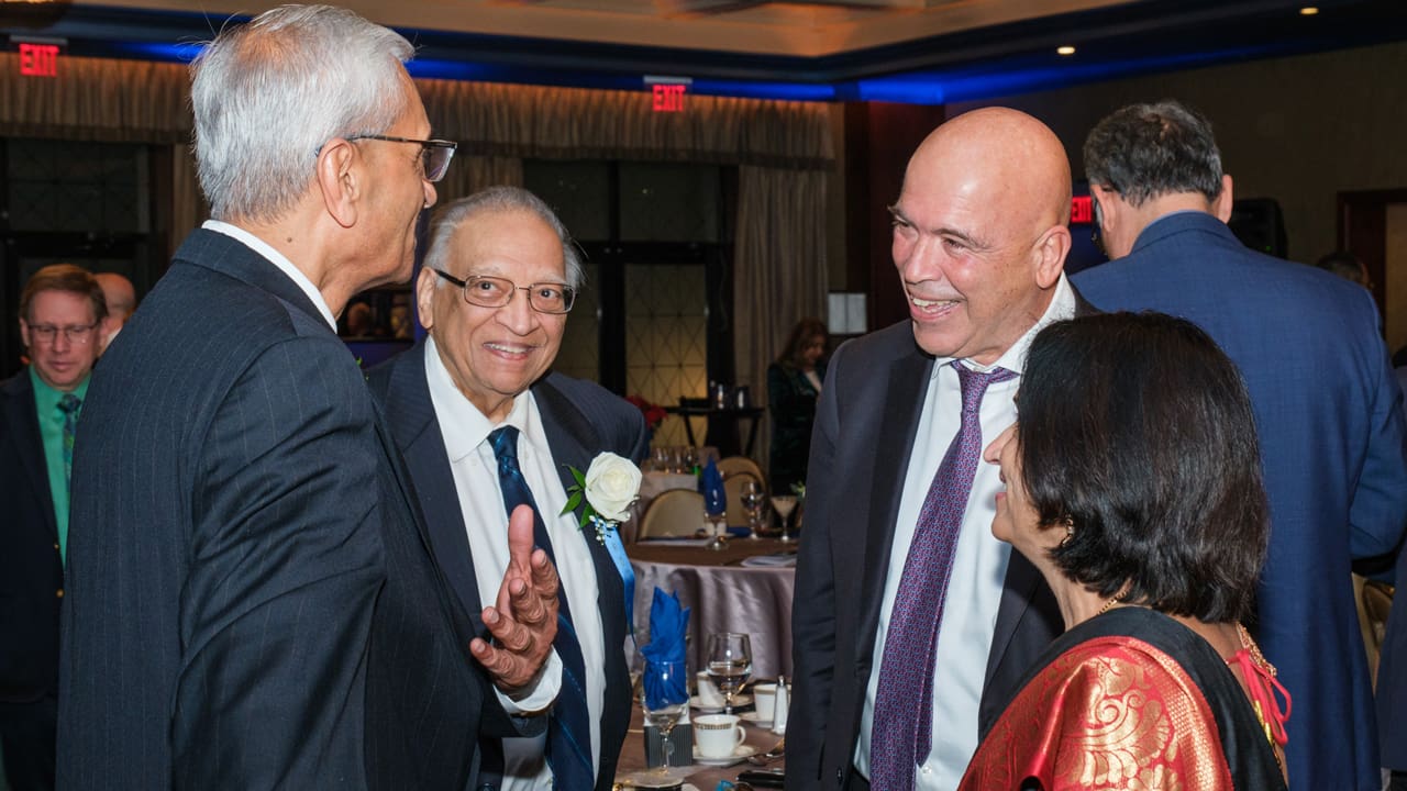 Four people engaged in conversation