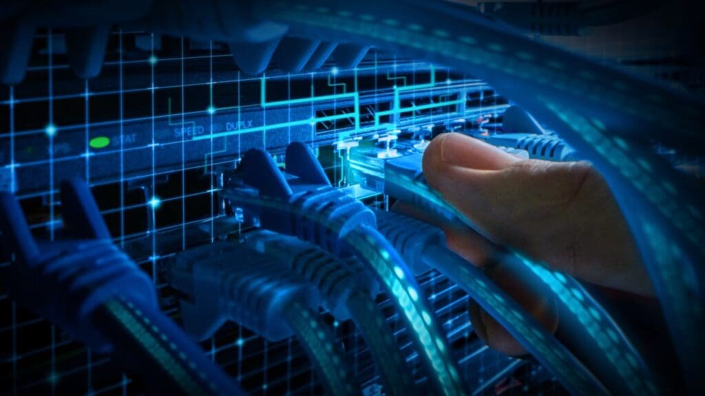 Person plugging in ethernet cables into a device.