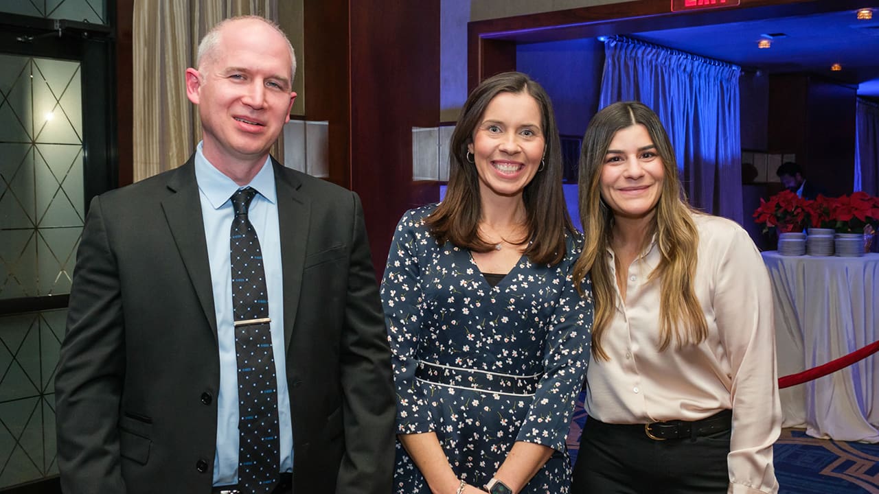 Three IEEE SA Awards attendees posing for a photo.