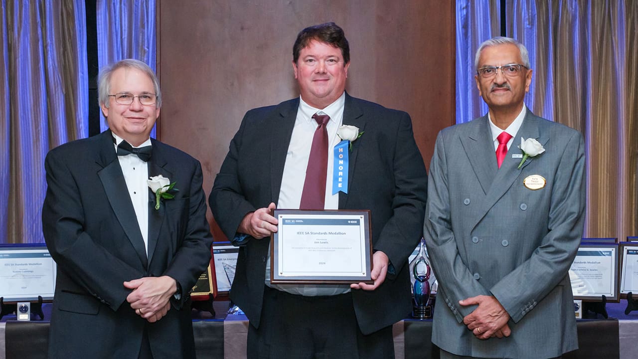 IEEE SA President Jim Matthews and Yatin Trivedi posing for a photo with an IEEE SA Awards honoree.