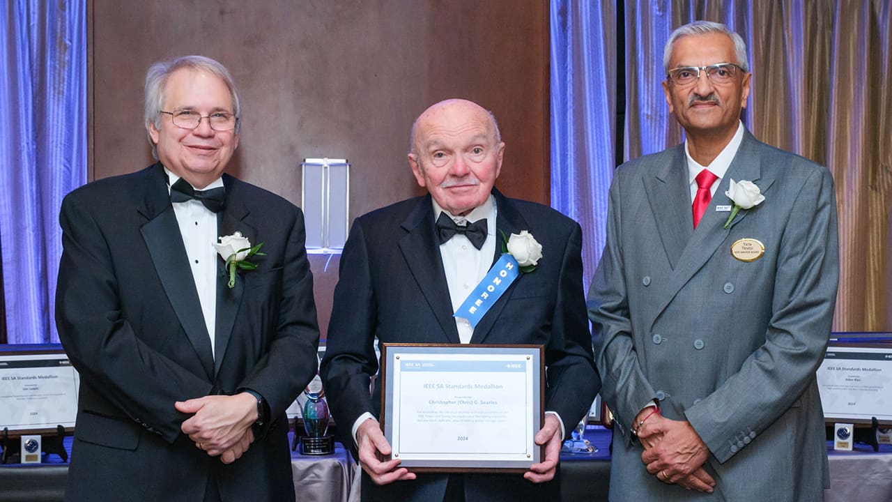 IEEE SA President Jim Matthews and Yatin Trivedi posing for a photo with an IEEE SA Awards honoree.