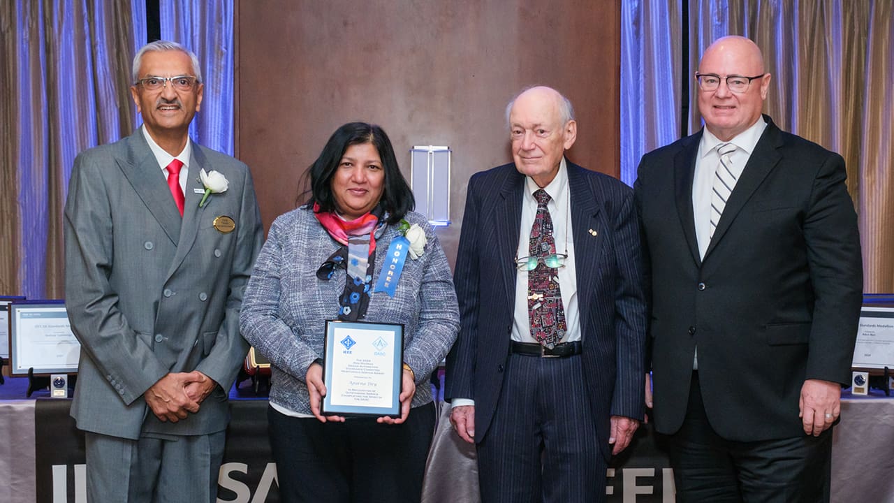 IEEE SA President Jim Matthews and Yatin Trivedi posing for a photo with IEEE SA Awards honorees.