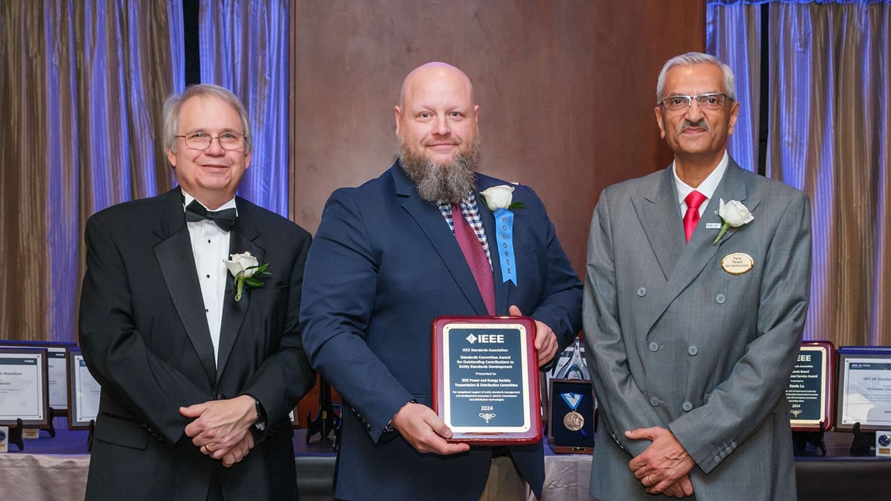 IEEE SA President Jim Matthews and Yatin Trivedi posing for a photo with an IEEE SA Awards honoree.