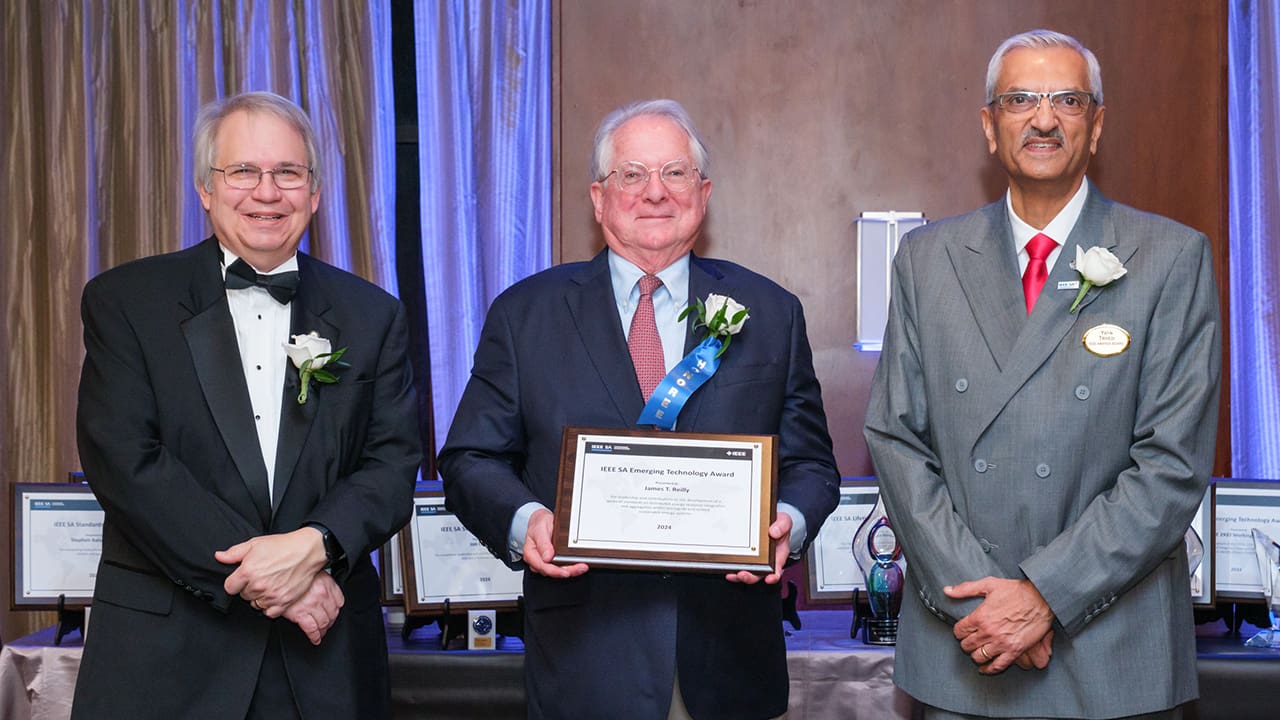 IEEE SA President Jim Matthews and Yatin Trivedi posing for a photo with an IEEE SA Awards honoree.