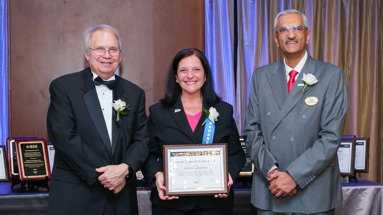 IEEE SA President Jim Matthews and Yatin Trivedi posing for a photo with an IEEE SA Awards honoree.