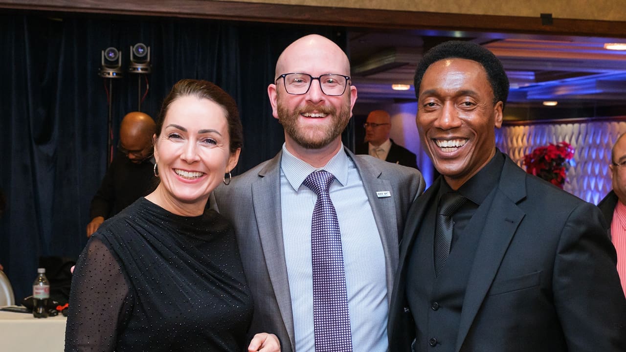 Three IEEE SA Awards attendees posing for a photo.