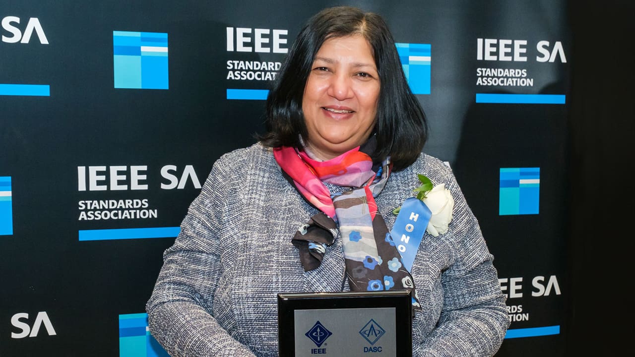 Aparna Dey holding their award at the 2024 IEEE SA Awards.