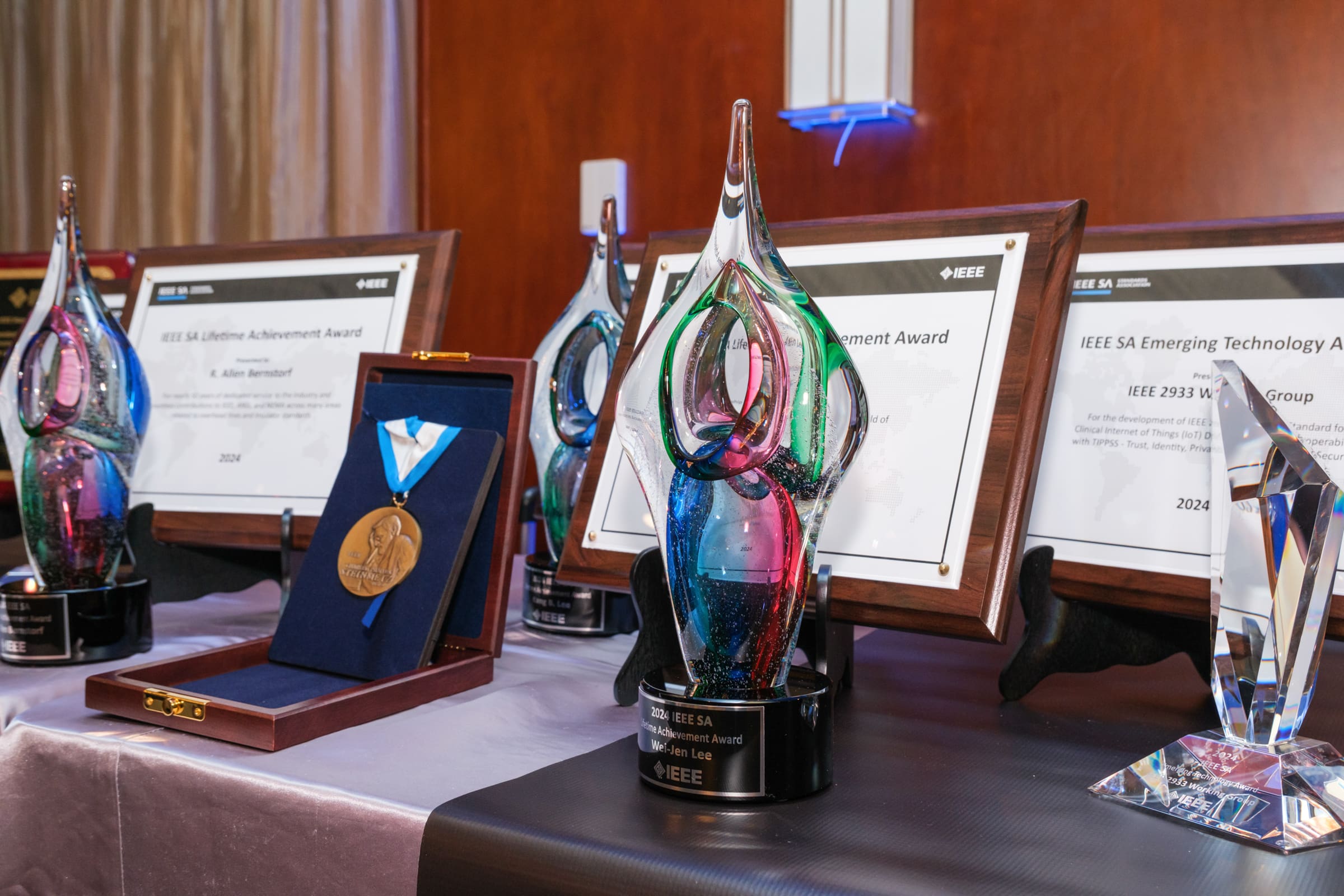 Multiple IEEE SA Awards sitting on a table.