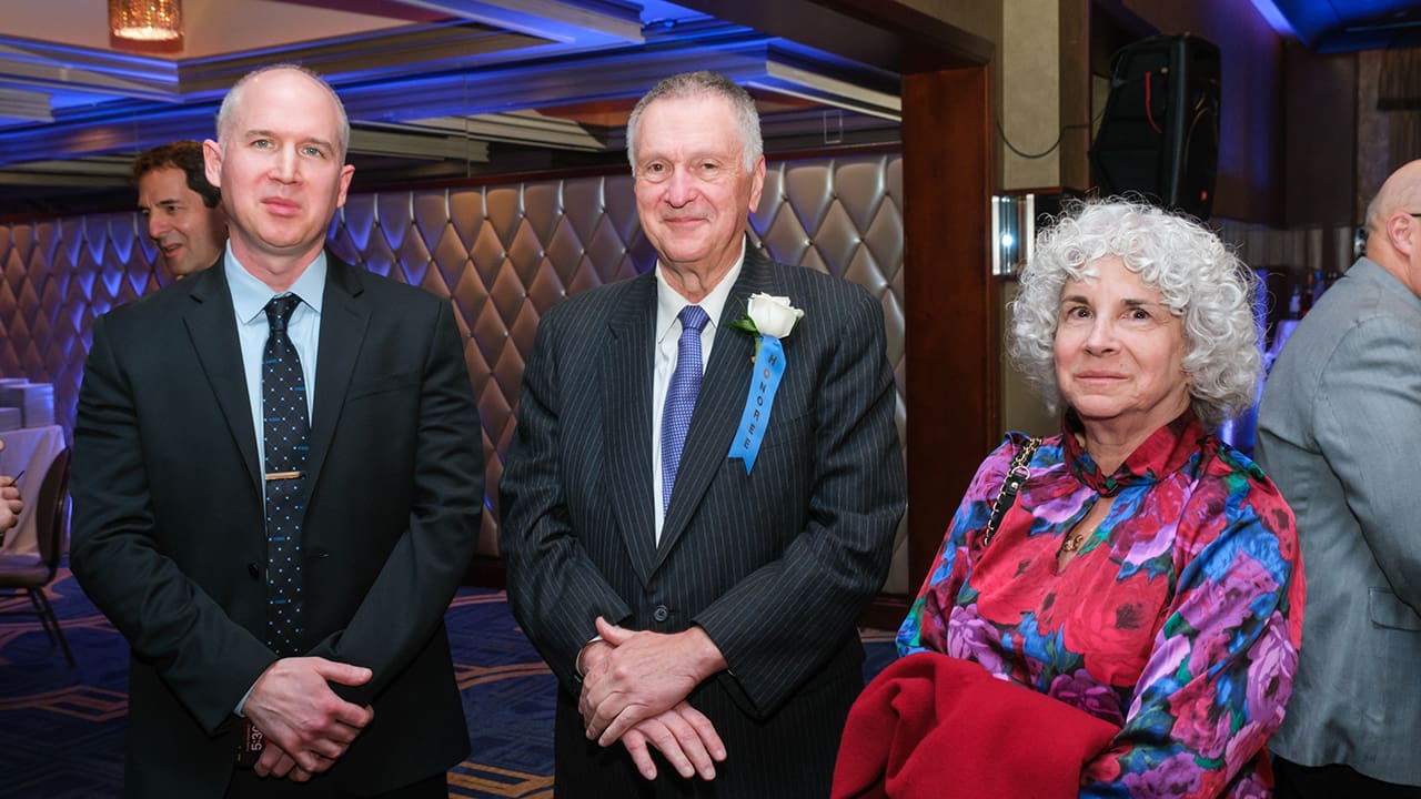 Three IEEE SA Awards attendees posing for a photo.