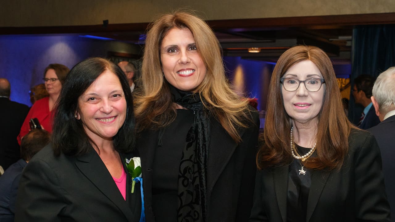 Three IEEE SA Awards attendees posing for a photo.