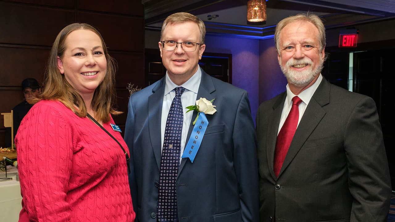 Three IEEE SA Awards attendees posing for a photo.