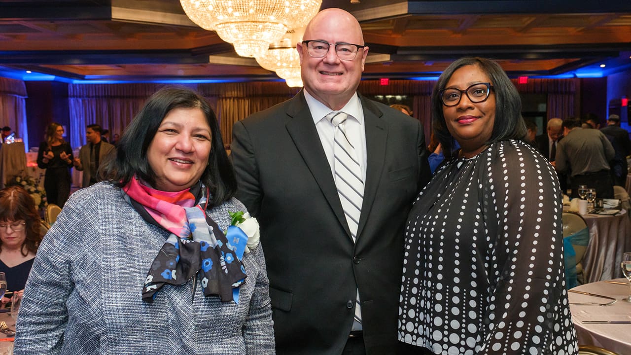 Three IEEE SA Awards attendees posing for a photo.