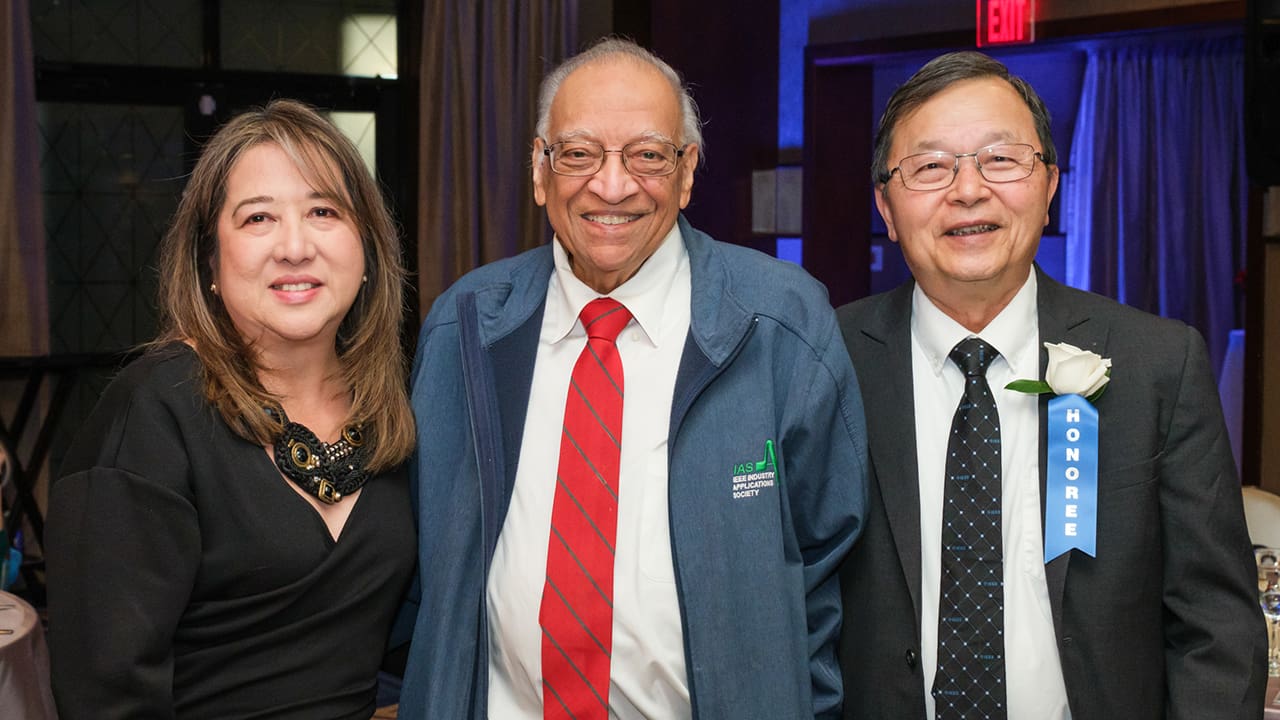 Three IEEE SA Awards attendees posing for a photo.