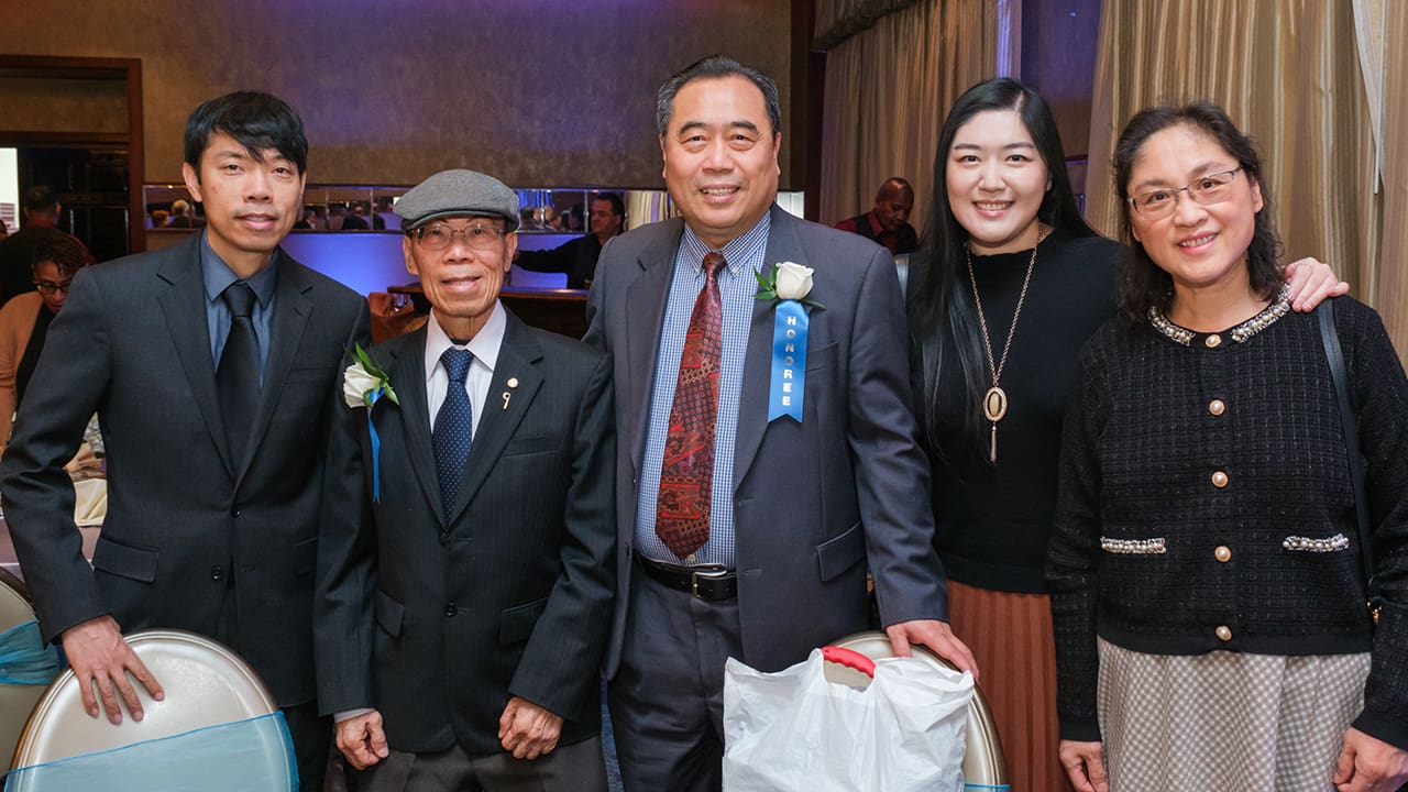 Five IEEE SA Awards attendees and honorees posing for a photo.