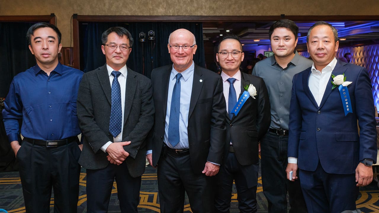 Six IEEE SA Awards attendees and honorees posing for a photo.