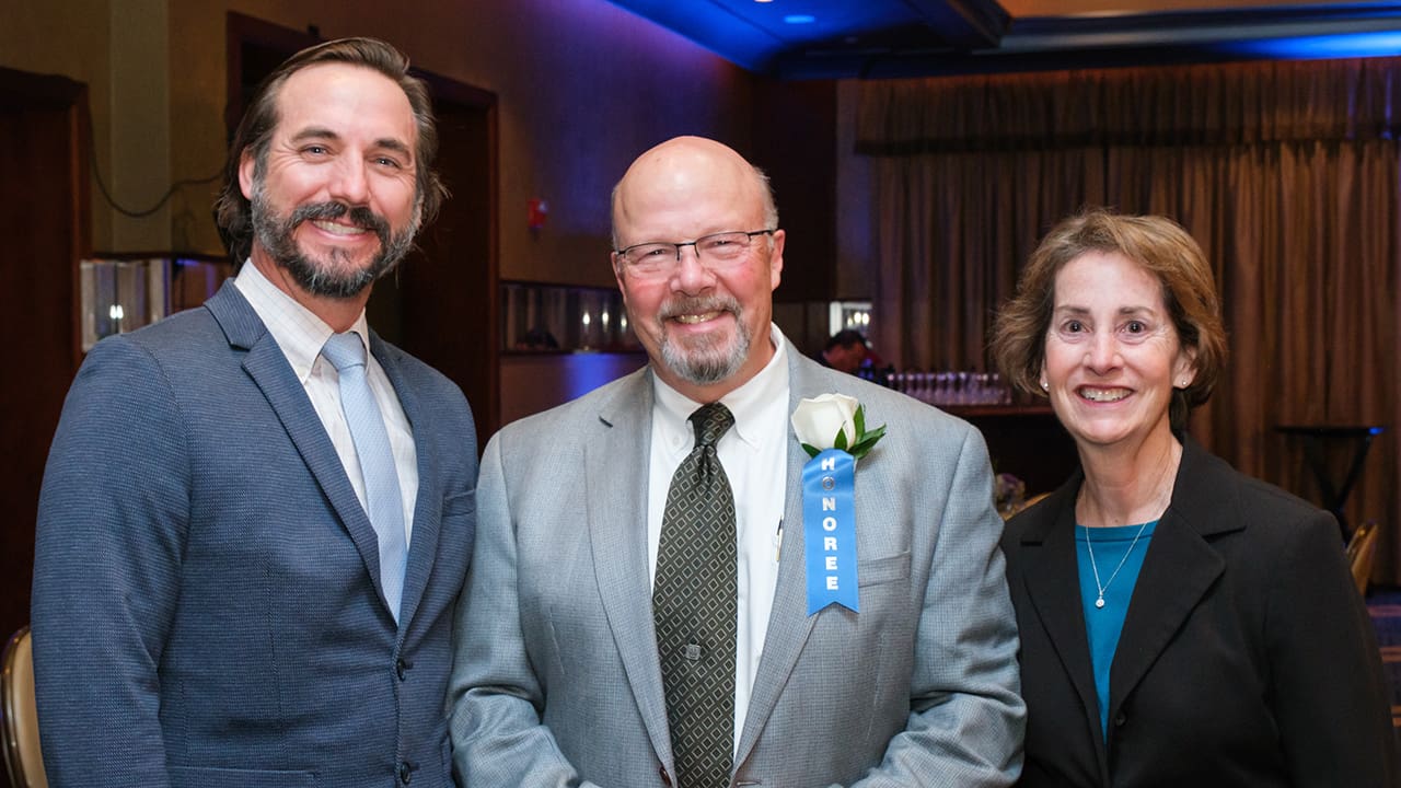 Three IEEE SA Awards attendees posing for a photo.