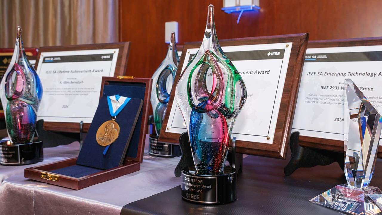 Multiple IEEE SA Awards sitting on a table.