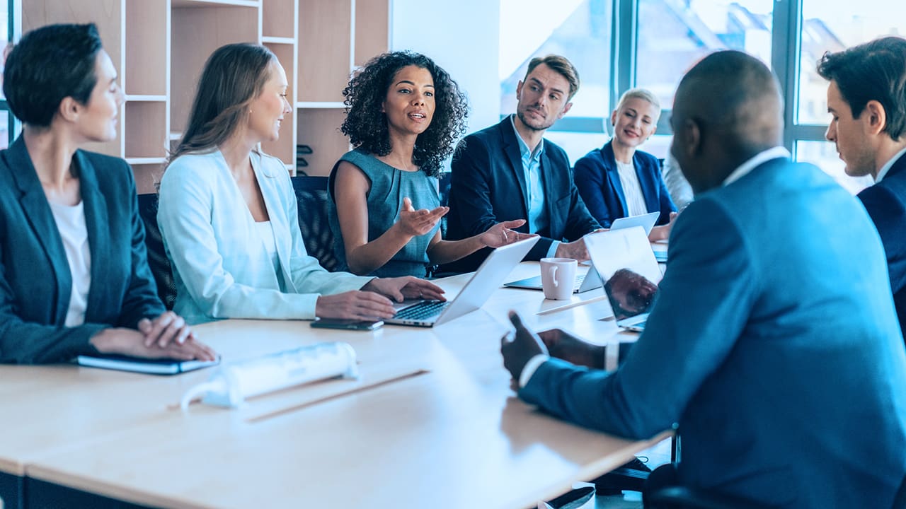 Group of people meeting at a table.