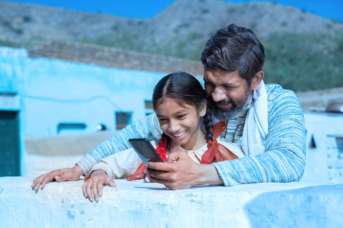 Father and daughter using phone